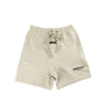 The front of the Fear Of God ESSENTIALS Dark Oatmeal Shorts.