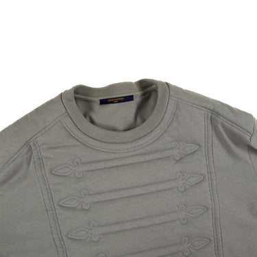 The collar and pattern of the Louis Vuitton Embroidered Plastron T-Shirt.