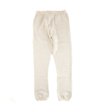 The back of the Fear Of God ESSENTIALS Light Oatmeal Sweatpants.