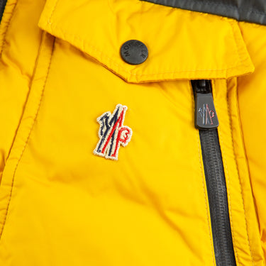 The logo of the Moncler Down Yellow Gilet.