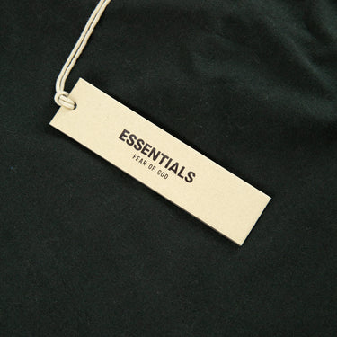 The tags of the Fear Of God ESSENTIALS Stretch Limo T Shirt.