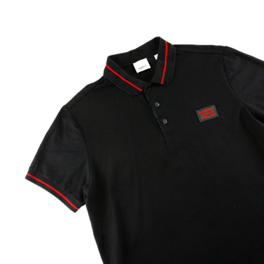 The flat lay of the Burberry London England Rubber Logo Black Polo Shirt.