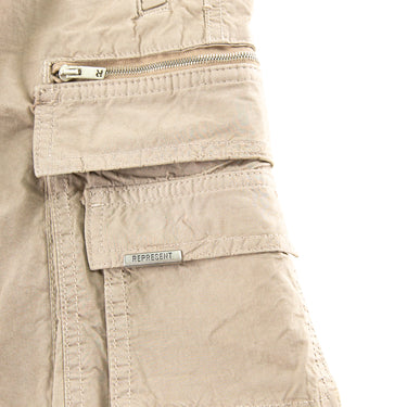 The pocket of the Represent Beige Cargo Trousers.